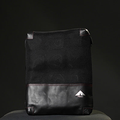 A black seat cover made of leather and air mesh, featuring a structured design with a visible brand logo on the lower right corner.